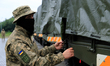 DNIPRO, UKRAINE - SEPTEMBER 20, 2022 - A Ukrainian serviceman stands by one of the heavy-d...