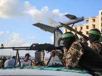 Members of the Ezzedine al-Qassam Brigades, the military wing of the Palestinian Islamist movement Hamas, attend a memorial to a model of "S...
