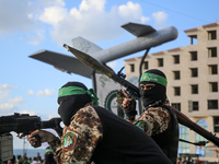 Members of the Ezzedine al-Qassam Brigades, the military wing of the Palestinian Islamist movement Hamas, attend a memorial to a model of "S...