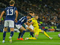 Artem Dovbyk of Ukraine stretches for the ball while Scott McKenna of Scotland during the UEFA Nations League match between Scotland and Ukr...