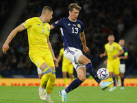 Jack Hendry of Scotland controls the ball under pressure from Artem Dovbyk of Ukraine during the UEFA Nations League match between Scotland...
