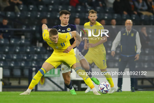 Kieran Tierney of Scotland National Team wins the ball ahed of Artem Dovbyk of Ukraine during the UEFA Nations League match between Scotland...