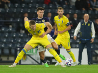 Kieran Tierney of Scotland National Team wins the ball ahed of Artem Dovbyk of Ukraine during the UEFA Nations League match between Scotland...