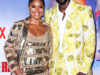 American actress Gabrielle Union wearing Valentino and husband/American former professional basketball player Dwyane Wade wearing Gucci arri...
