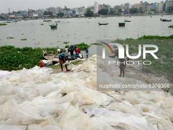 Workers dries reject plastic bag on the bank of Buriganga River in Dhaka, Bangladesh, on September 25, 2022. World Rivers Day is observed on...