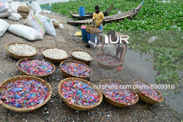 
Worker washes recycled plastic chips in the river Buriganga in Dhaka, Bangladesh, on September 25, 2022. World Rivers Day is observed on Se...