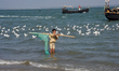 A boy fishing by net on the shores of the Bay of Bengal at village Naziratek in Cox's Baza...