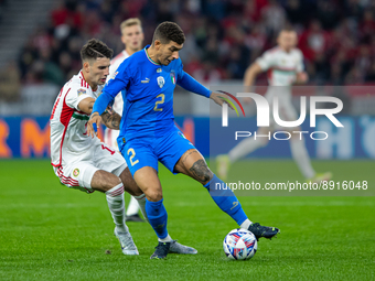Giovanni Di Lorenzo of Italy competes for the ball with Dominik Szoboszlai of Hungary during the UEFA Nations League A3 match at Puskás Arén...