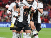 LONDON ENGLAND - SEPTEMBER 26 :Ilkay Gundogan (Manchester City) of Germany celebrates his goal with David Raum of Germany and Leroy Sane (Ba...