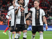 LONDON ENGLAND - SEPTEMBER 26 :Ilkay Gundogan (Manchester City) of Germany celebrates his goal with David Raum of Germany and Leroy Sane (Ba...