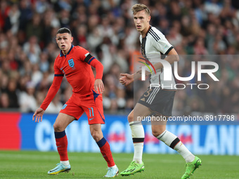 LONDON ENGLAND - SEPTEMBER 26 : L-R Phil Foden (Man City) of England and Nico Schlotterbeck of Germany during UEFA Nations League - Group A3...