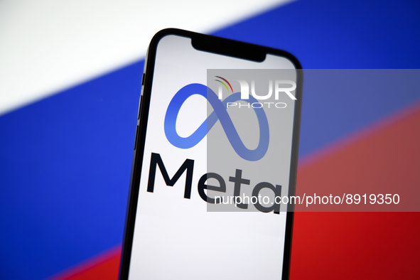 The Meta logo is seen on a mobile phone with the Russian flag in the background in this photo illustration in Warsaw, Poland on 27 September...