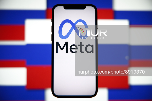 The Meta logo is seen on a mobile phone with the Russian flag in the background in this photo illustration in Warsaw, Poland on 27 September...