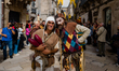 Two figures pose during the procession, in the historic center of Altamura on 1 October 20...