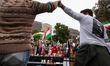 Thousands of people attend a protest for Mahsa Amini, freedom in Iran, and solidarity with...
