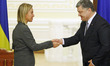 Ukrainian President Petro Poroshenko (R) shakes hands with the High Representative of the...