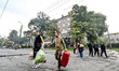 ZAPORIZHZHIA, UKRAINE - OCTOBER 10, 2022 -  People carry their belongings after rocket att...