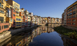A general view of the riverside buildings and their reflections in the River Onyar, Girona...