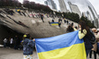 Members of Ukrainian diaspora hold Ukrainian flag before a demonstration of solidarity wit...
