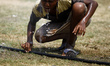 A boy drinking water from water pipe while playing on field.People in the capital experie...