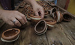 Members of the Mejía family arrange clay moulds for making sugar skulls inside a home in X...