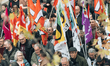Flags of the different unions that called for the strike day are seen during a demonstrati...
