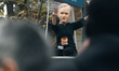 A demonstrator from the ATTAC association wears a mask of billionaire Bernard Arnault, maj...