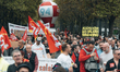 A CGT union marchers hold up a sign demanding a €400 net monthly pay rise during a demonst...
