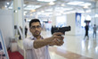 An Iranians man practices shooting with a shooting simulator made in Iran at a shooting si...