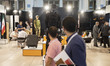 Iranian visitors walk past a mannequin decorated with military safety equipments at the bo...