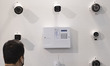 Iranian visitors stand at a booth of the Vizitron IP camera manufacturer company, at the n...