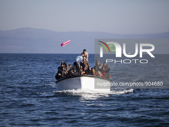 Refugees and migrants riding a dinghy reach the shores of the Greek island of Lesbos after crossing the Aegean Sea from Turkey on November 1...