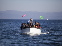 Refugees and migrants riding a dinghy reach the shores of the Greek island of Lesbos after crossing the Aegean Sea from Turkey on November 1...