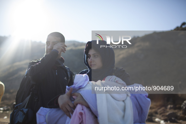 A woman from Syria embraces her son as refugees and migrants riding a dinghy reach the shores of the Greek island of Lesbos after crossing t...