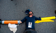 An activist is laying on the ground blocking with his body the street, during a massive cl...