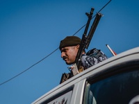 A portrait of a member 1 Iraqi Kurdish leader Massud Barzani announced the "liberation" of Sinjar from the Islamic State group in an assault...