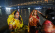 Devotees are seen offering prayers and food items as gift to Sun god on the eve of Chhath...