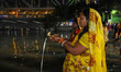 Devotees are seen offering prayers to Sun god on the eve of Chhath puja in Kolkata , India...