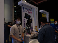 A stand promotes a ''bitcoin gift card'' during the Fintech week in Hong Kong. The Hong Kong government has announced plans to allow retail...