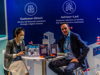 John Robson, Chief Commercial Officer of Quantifeed, a wealth management solutions company is seen on a stand of his company during the Fint...
