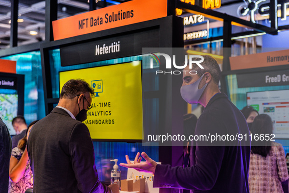 An exhibitor presents his NFT data solution to a participant of the Fintech Week,in Hong Kong, on November 01, 2022. 