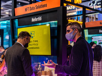 An exhibitor presents his NFT data solution to a participant of the Fintech Week,in Hong Kong, on November 01, 2022. (