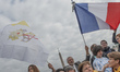 A pilgrim waves flag of Vatican State and French Flag, during Pope Francis general audienc...