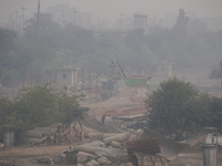 A worker walks past a construction site enveloped in a thick layer of smog and haze in New Delhi, India on November 3, 2022. Delhi's air qua...