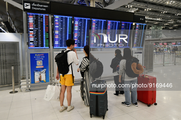 Travelers seen check departure time at Suvarnbhumi International Airport on November 9, 2022 in Sumut Prakan, Thailand. 