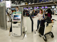 Travelers seen check-in for flight by Auto Check-in System  inside the departure terminal of the Suvarnabhumi International Airport on Novem...