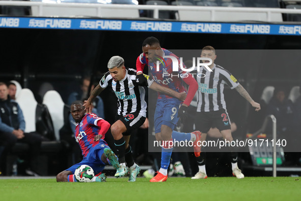 Newcastle United's Bruno Guimaraes battles for possession with Crystal Palace's Tyrick Mitchell and Jordan Ayew during the Carabao Cup Third...