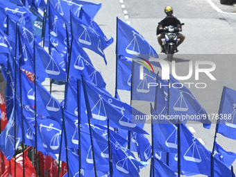 A motorcyclist rides past the party flags  during the campaign period of Malaysia's general election in Kuala Lumpur on 11 November, 2022....