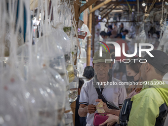 A vendor receives payment from consumer at Parung ornamental fish market in Bogor of West Java province on 12 November 2022. Parung ornament...