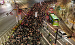 People march towards the presidential office during the 15th candlelight vigil around Seou...
